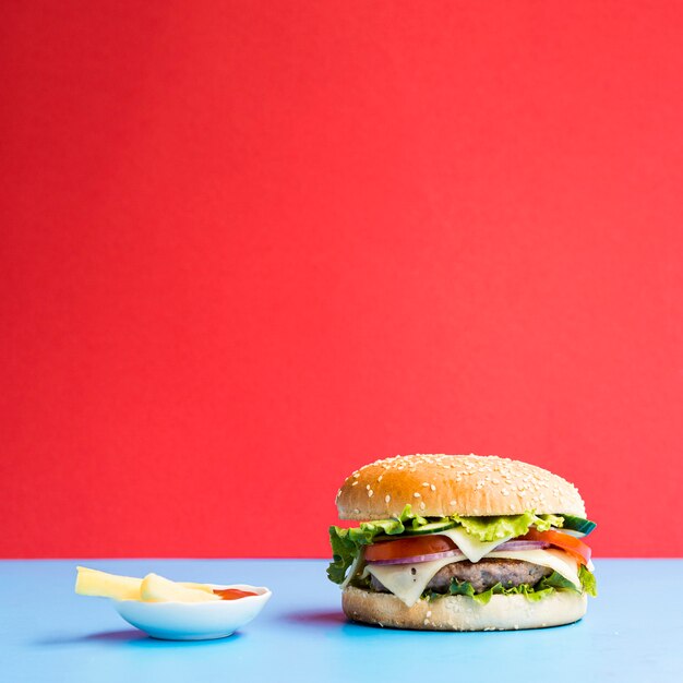 Burger on blue table with red background