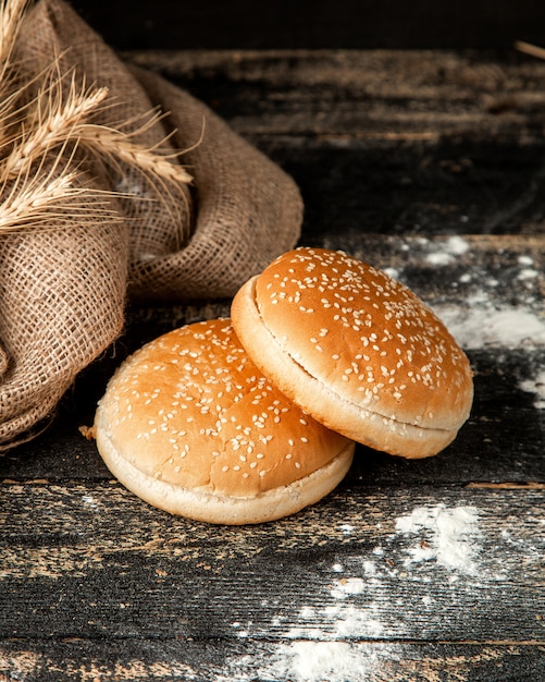 Free Photo burger buns with sesame seeds wheat and flour on table