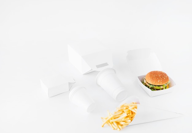 Free Photo burger; french fries; disposal cup and food parcel mock up on white background