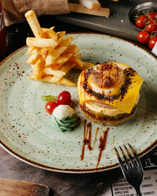 burger with french fries and tomatoes on plate