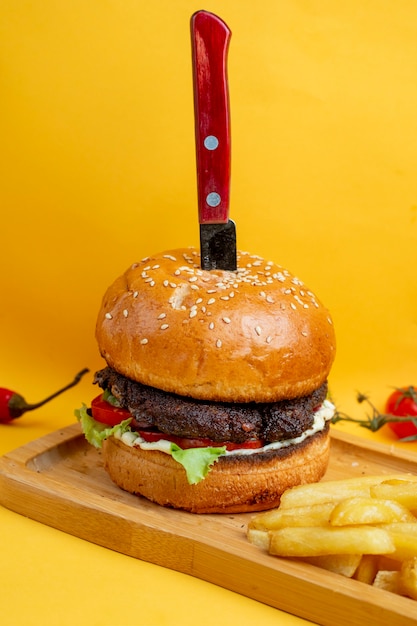 Burger with knife inside and fries