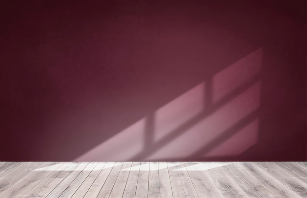 Free photo burgundy red wall in an empty room with a wooden floor