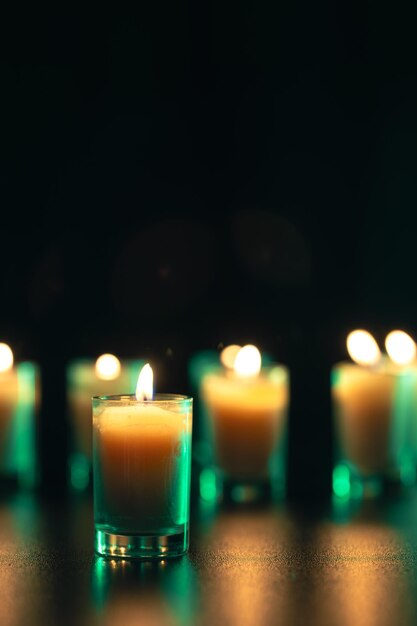 Burning candle on black background with backlight Memorial Day