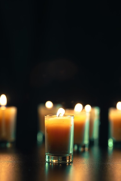 Burning candle on black background with backlight Memorial Day