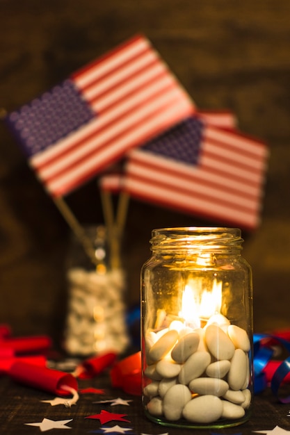 Free photo burning candles in the candies jar for independence day celebration