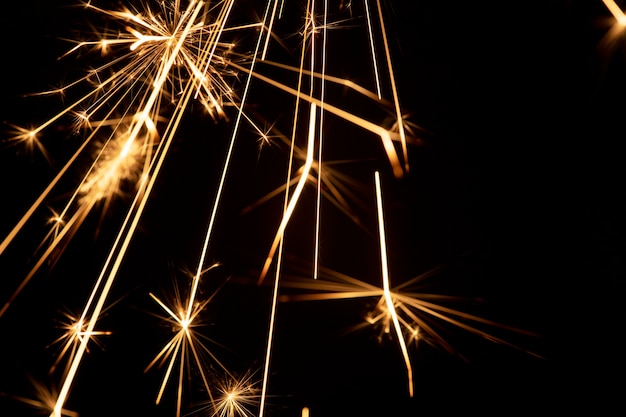 Burning sparkler on a black background wallpaper