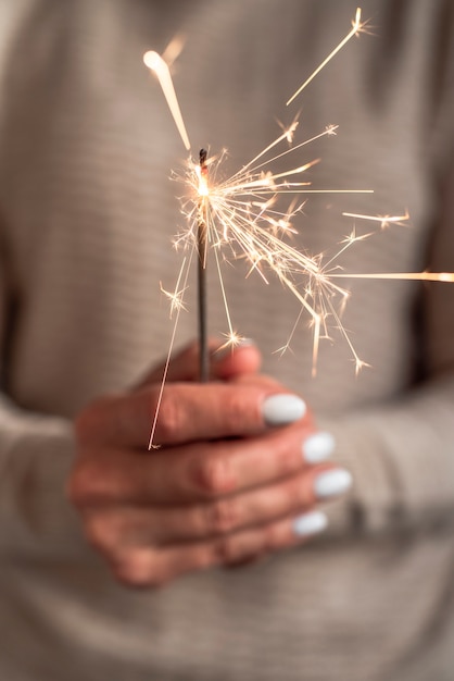 Free photo burning sparkler blast held in hand