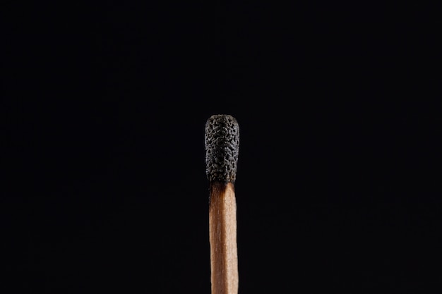 Free photo burnt match with dark background