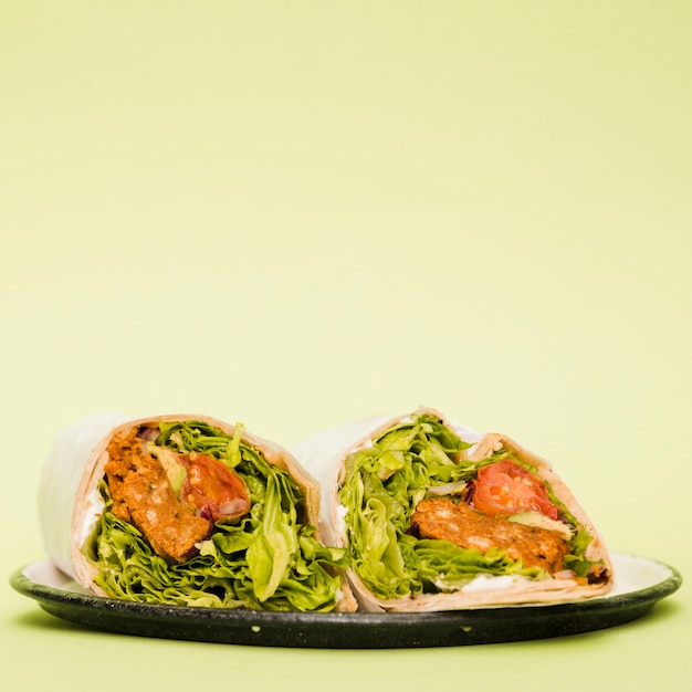 Free Photo burrito wraps on plate over mint green background