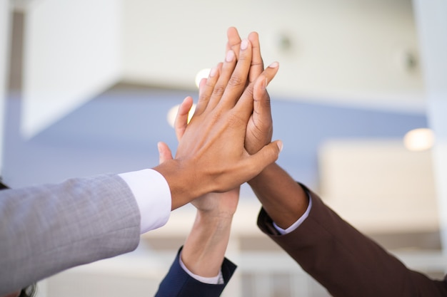 Business colleagues celebrating success and joining hands