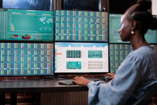 Business company professional agent sitting at desk in office workspace while trying to predict market trend. Forex stock trader monitoring live financial graphs in order to gain profits.