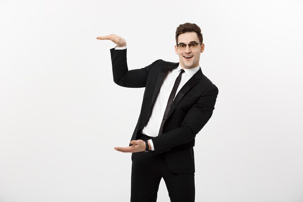 Business Concept - Handsome young business man happy smile, businessman showing something on the open palm, concept of advertisement product isolated over white background