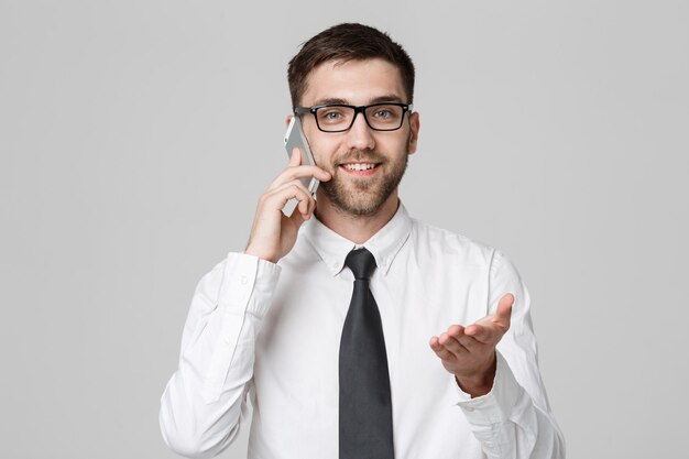 Business Concept Portrait Handsome Business man on phone with smiling confident face White BackgroundCopy Space