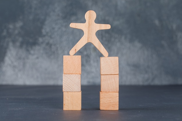 Free photo business concept with wooden blocks with wooden human figure.