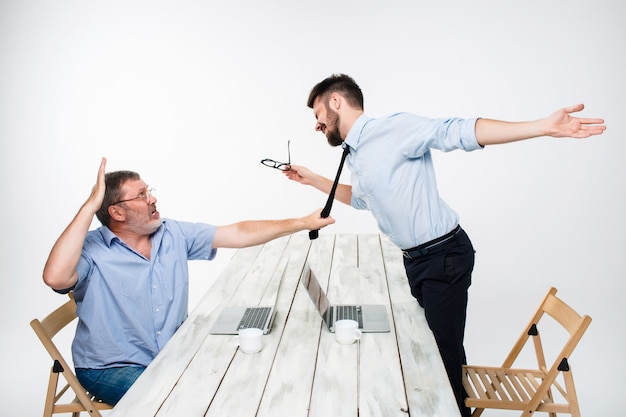 Free Photo business conflict. the two men expressing negativity while one man grabbing the necktie of her opponent