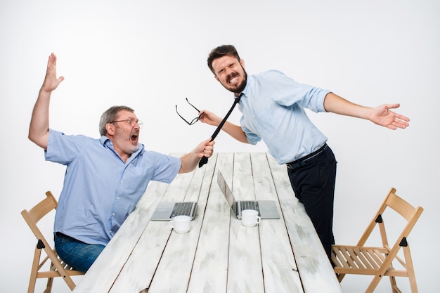 Free Photo business conflict. the two men expressing negativity while one man grabbing the necktie of her opponent