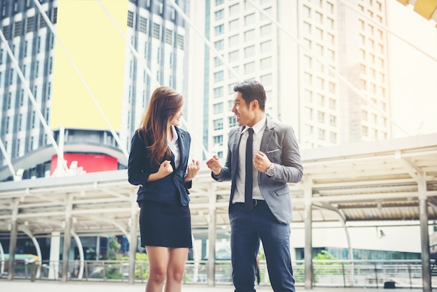 Business couple hands up doing yes outdoor. Concept of teamwork