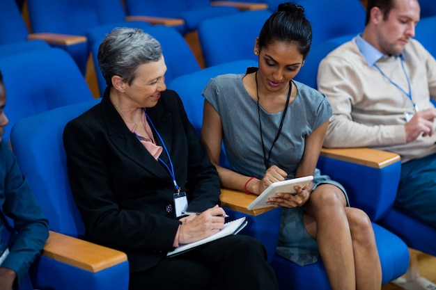 Business executives participating in a business meeting using digital tablet