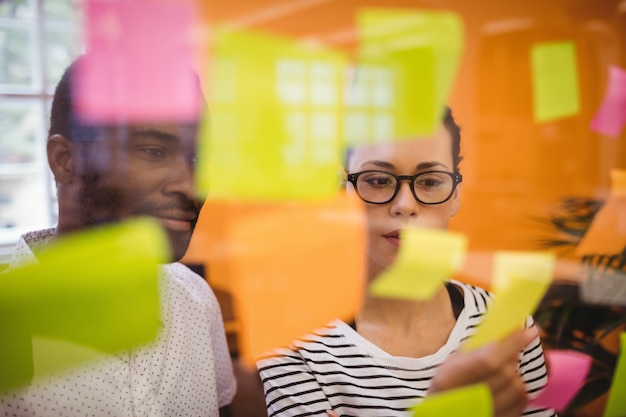 Free Photo business executives reading sticky notes