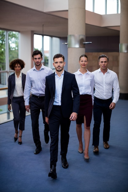 Business executives walking in a conference center lobby