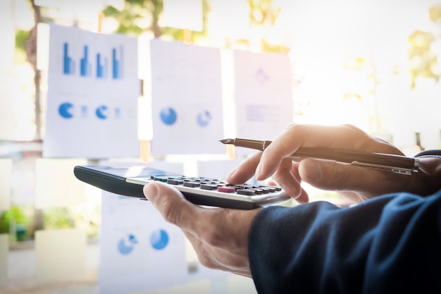 Business finance man calculating budget numbers, Invoices and financial adviser working.