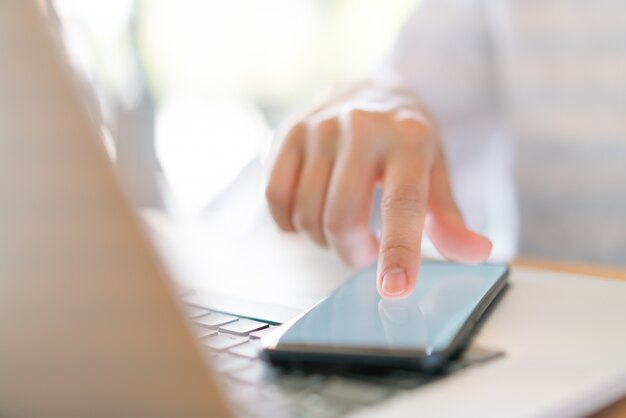 Business hand with mobile phone .