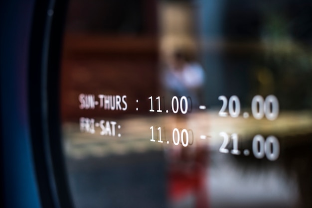 Free photo business hours announcement on a window