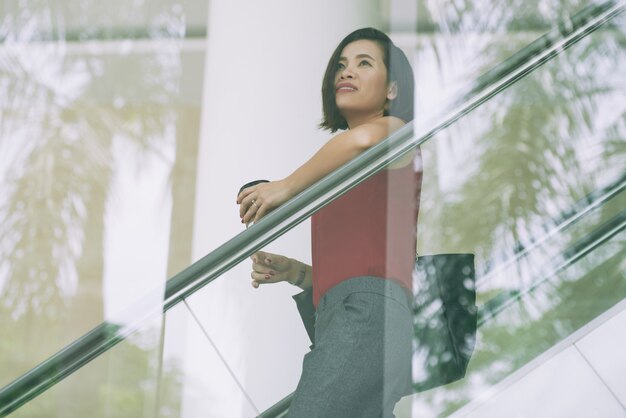 Business lady on escalator