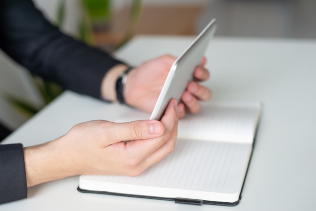 Business leader analyzing report on tablet screen