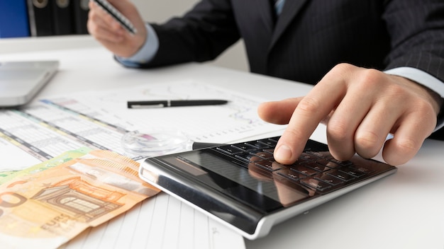 Business man calculating finance numbers close-up