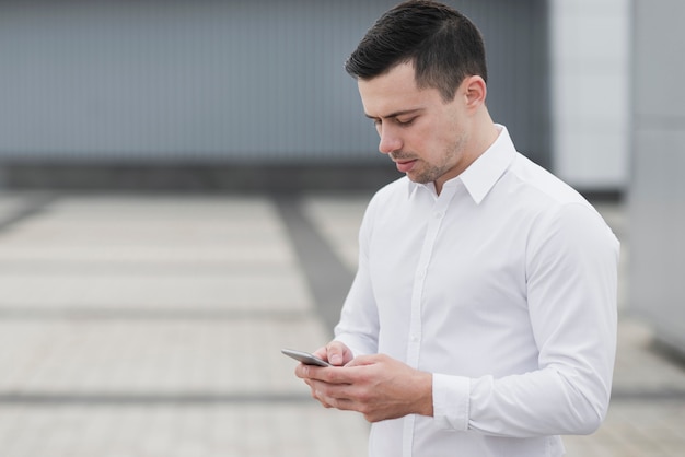 Free photo business man checking phone