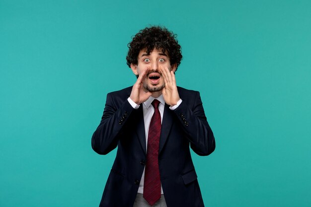 Business man curly cute handsome guy in black suit calling for help