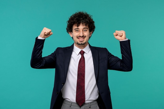 Business man curly cute handsome guy in black suit excited holding fists