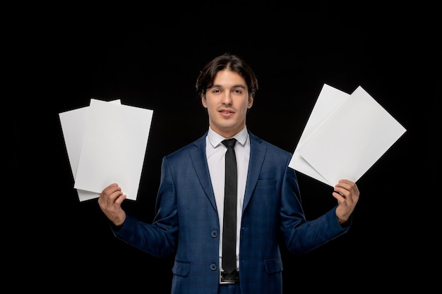 Free photo business man cute brunette guy in dark blue suit with the tie holding paper sheets