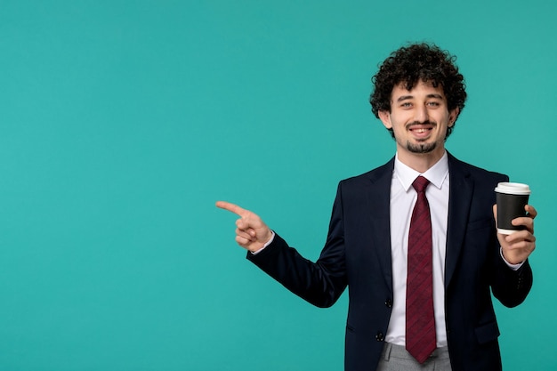 Business man handsome cute young guy in black suit and red tie smiling and holding coffee cup