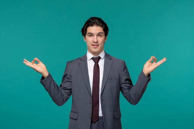 Free Photo business man handsome young brunette guy in grey office suit and tie showing zen gesture