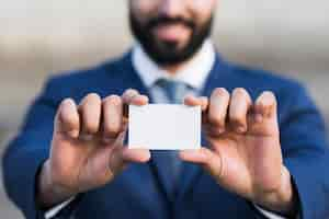 Free photo business man holding business card