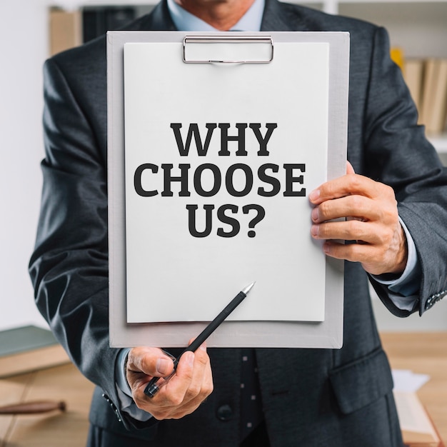 Free Photo business man holding a clipboard with the why choose us question