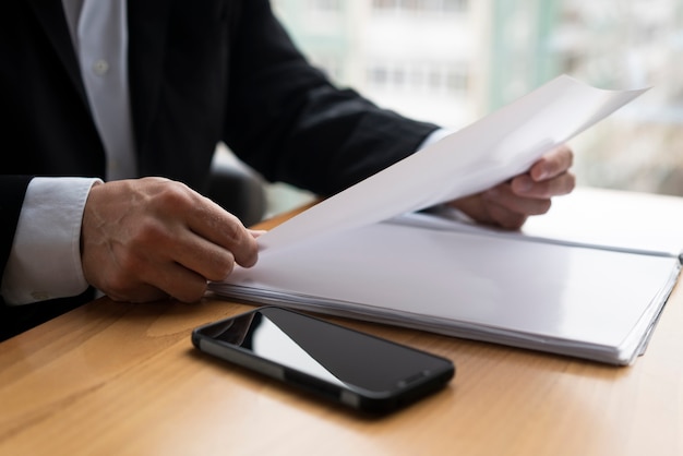 Free photo business man holding glossy paper