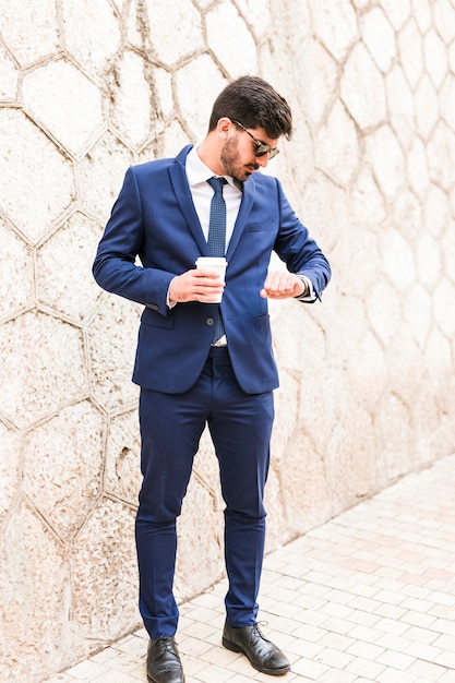 Free Photo business man looking at his watch