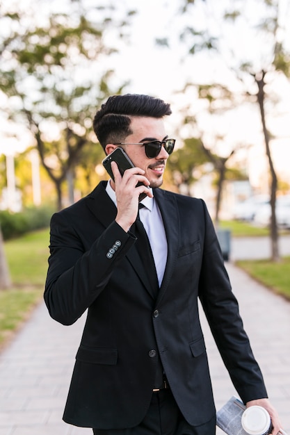 Business man on the phone at the park