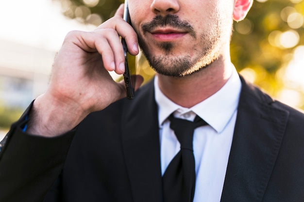 Free photo business man on the phone at the park