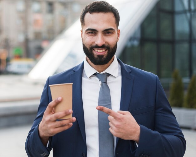 Business man pointing at coffee