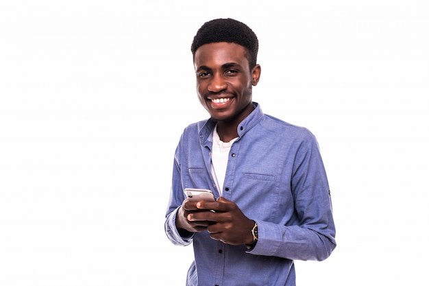 Business man texting on his mobile phone isolated over a white wall