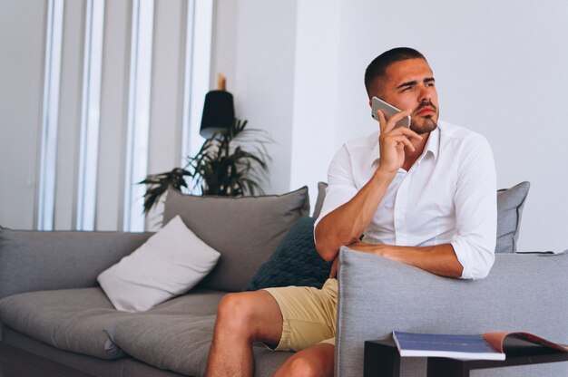 Business man with phone sitting in hall