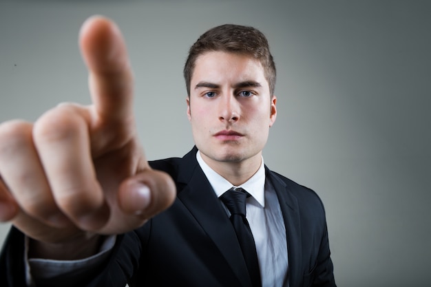 Free photo business man with pointing to something or touching a screen.