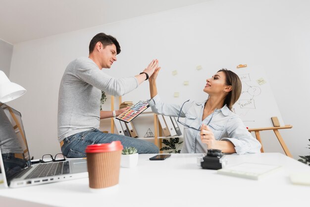 Business man and woman high five