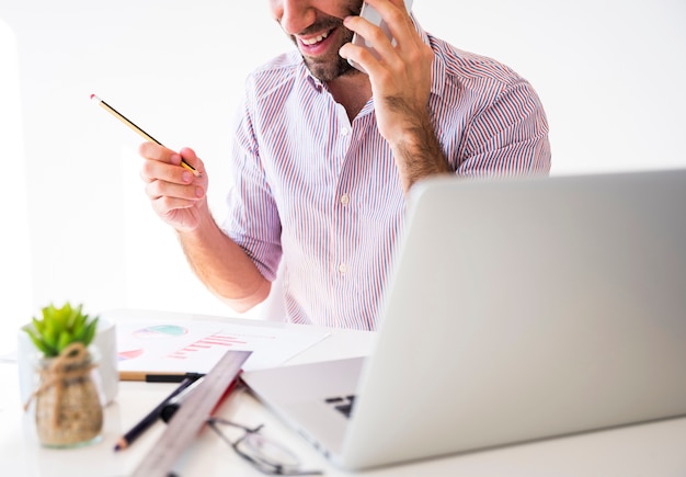 Business man working with a mobile phone and a laptop