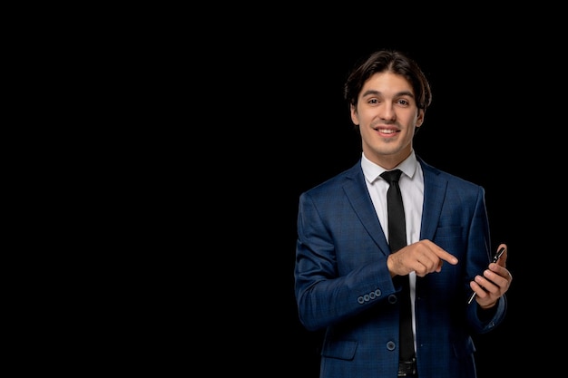 Business man young handsome guy in dark blue suit with the tie holding phone