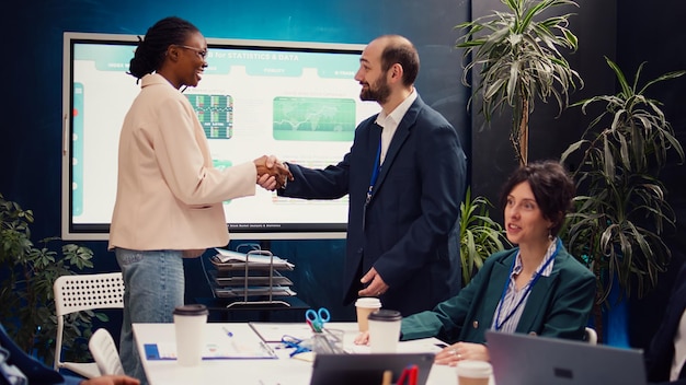 Business manager does handshake with a new employee during a briefing meeting